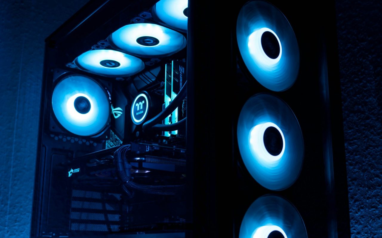 A black gaming PC tower with icy blue fans